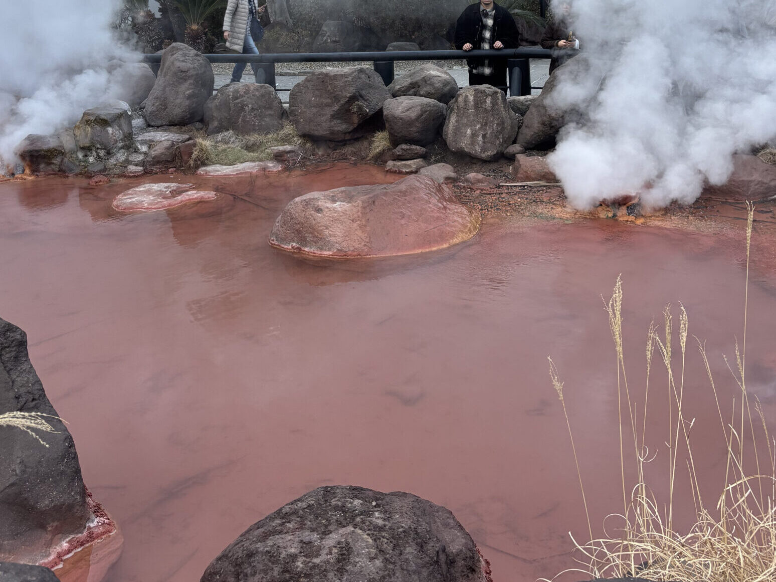 Steaming, blood-red hot spring water of Chinoike Jigoku in Beppu Onsen - Japan Navi Journey